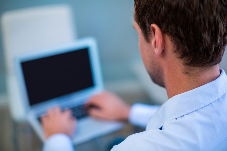 Dentist working at a computer in the clinic